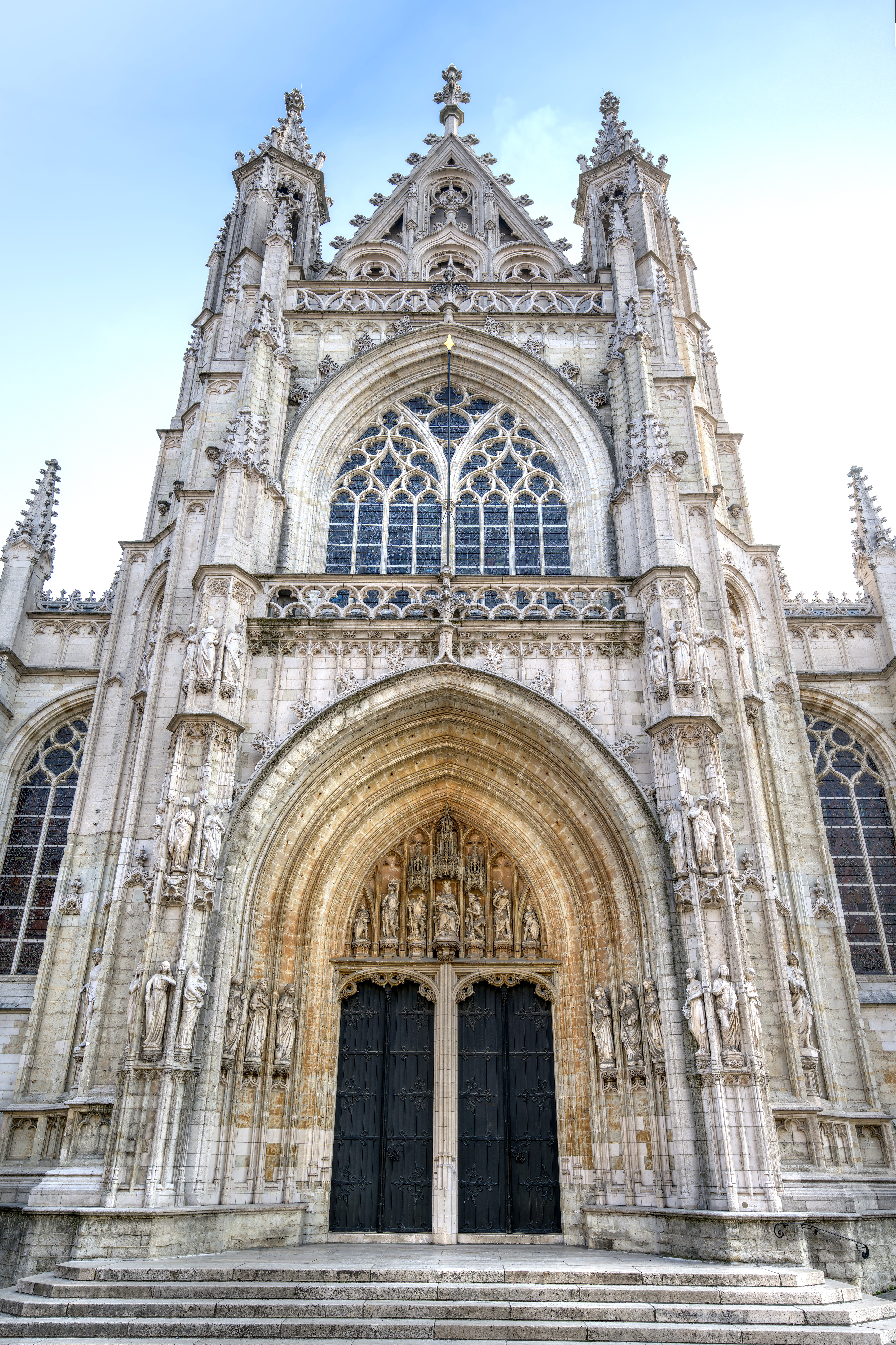 Stone statues on an ornate façade of the church of Notre-Dame au Sablon in Brussels.